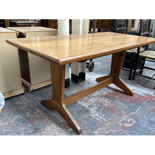 1024 - A 1970s Reynolds of Ludlow walnut dining table - approx. 73cm high x 76cm wide x 151cm long