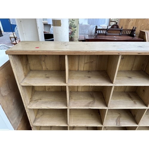 1027 - A Victorian style pine twenty section shelving unit - approx. 142cm high x 147cm wide x 23cm deep