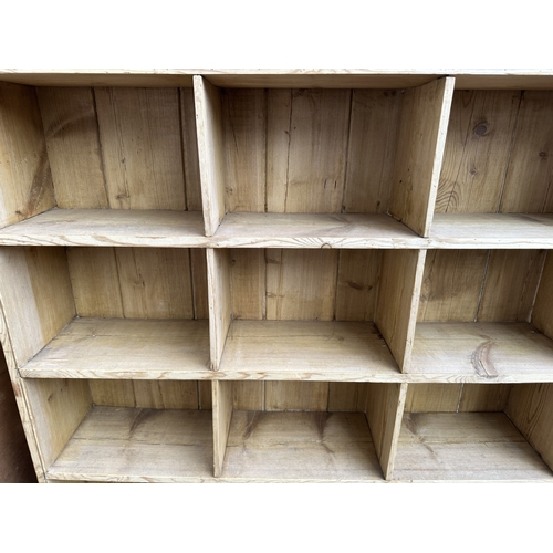1027 - A Victorian style pine twenty section shelving unit - approx. 142cm high x 147cm wide x 23cm deep