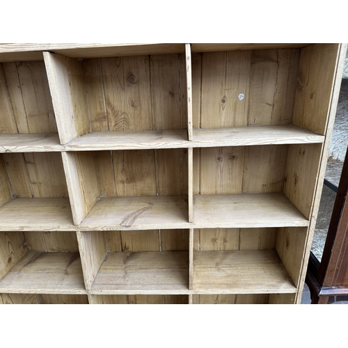 1027 - A Victorian style pine twenty section shelving unit - approx. 142cm high x 147cm wide x 23cm deep