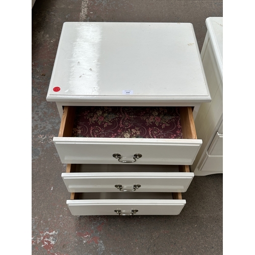 1028 - Two white painted bedside chests of drawers - approx. 62cm high x 57cm wide x 45cm deep