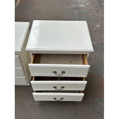1028 - Two white painted bedside chests of drawers - approx. 62cm high x 57cm wide x 45cm deep