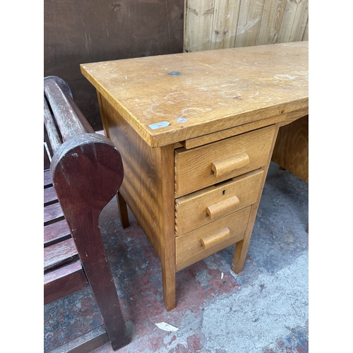 1030 - A mid 20th century oak pedestal writing desk - approx. 77cm high x 123cm wide x 61cm deep