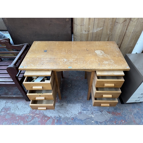 1030 - A mid 20th century oak pedestal writing desk - approx. 77cm high x 123cm wide x 61cm deep