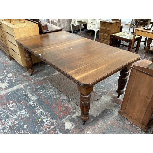 1038 - A Victorian walnut wind out dining table - approx. 74cm high x 104cm wide x 178cm long
