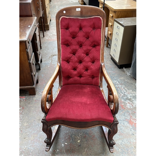 1046 - A 19th century mahogany and red button back fabric upholstered rocking chair - approx. 103cm high x ... 