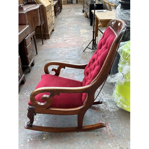 1046 - A 19th century mahogany and red button back fabric upholstered rocking chair - approx. 103cm high x ... 