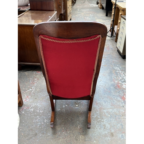 1046 - A 19th century mahogany and red button back fabric upholstered rocking chair - approx. 103cm high x ... 