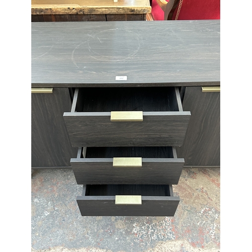 1052 - A modern black ash effect sideboard on black metal and brushed brass effect supports - approx. 74cm ... 