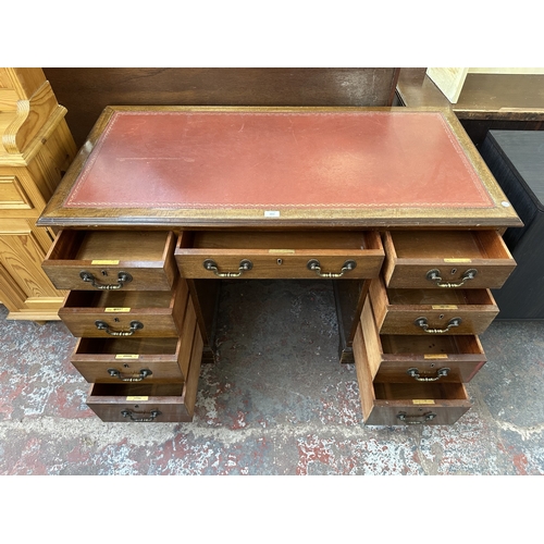 1053 - An early 20th century mahogany and red leather pedestal desk - approx. 77cm high x 123cm wide x 61cm... 