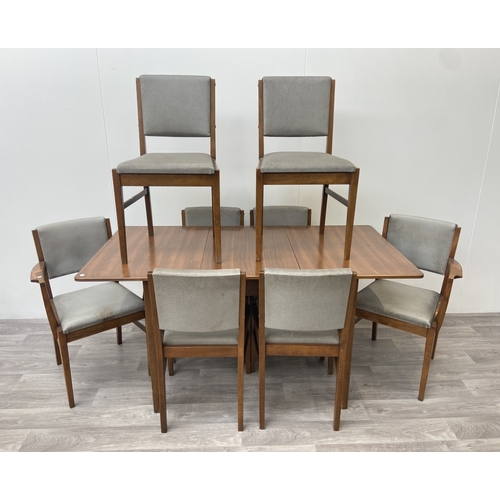 1131 - A mid 20th century Gordon Russell walnut dining table and eight chairs with grey vinyl upholstery - ... 