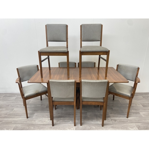 1131 - A mid 20th century Gordon Russell walnut dining table and eight chairs with grey vinyl upholstery - ... 