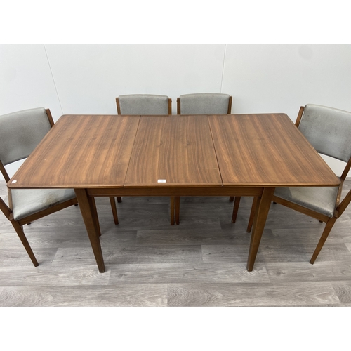 1131 - A mid 20th century Gordon Russell walnut dining table and eight chairs with grey vinyl upholstery - ... 