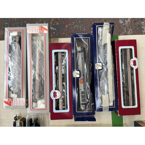 A collection of boxed and unboxed model railway vehicles and ...