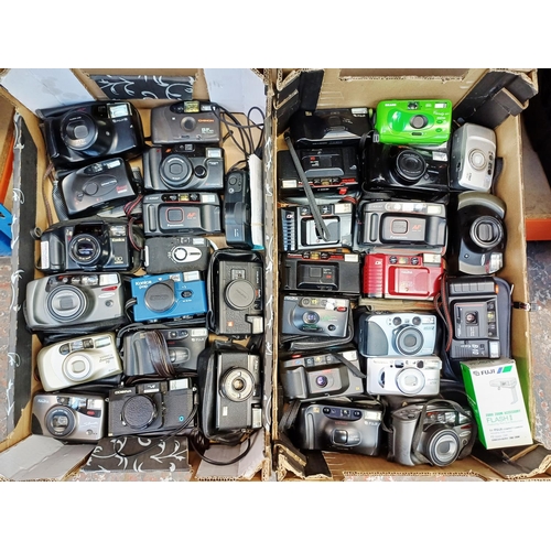 Two boxes containing cameras to include Konica, Yashica, Fuji, Halina etc.