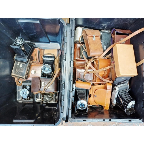 Two boxes containing folding cameras