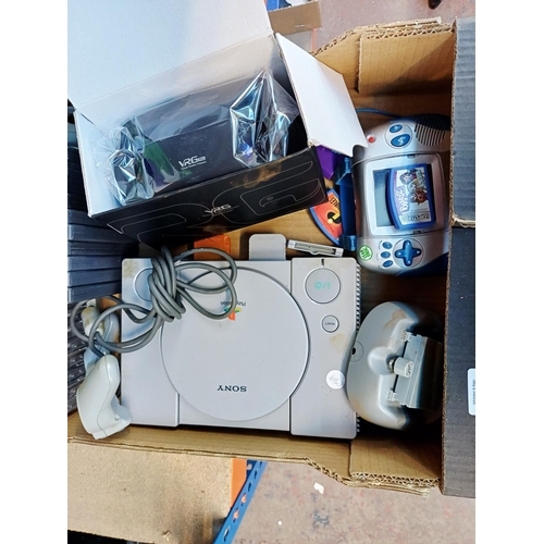 A box containing Sony PlayStation games console with eight game discs ...