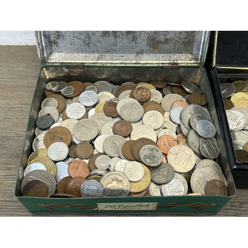 Two tins containing a collection of world coins with silver examples to ...