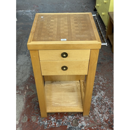A modern beech kitchen island/butcher's block containing utensils ...