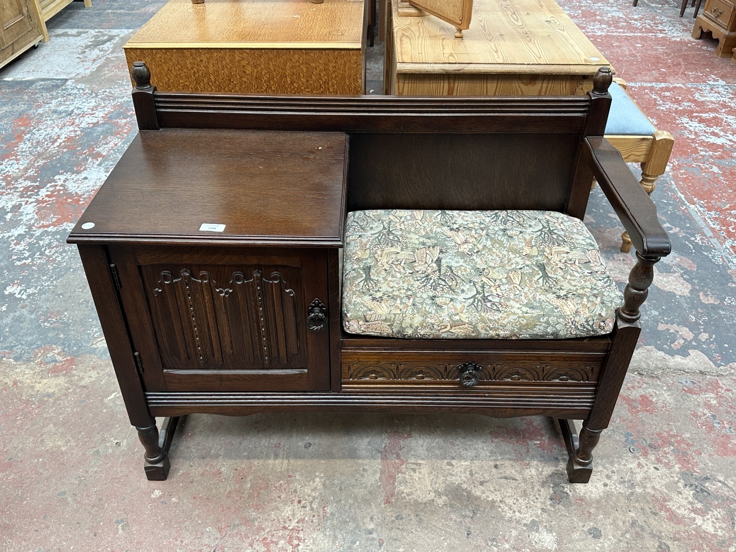 A carved oak linenfold telephone table - approx. 77cm high x 98cm wide ...