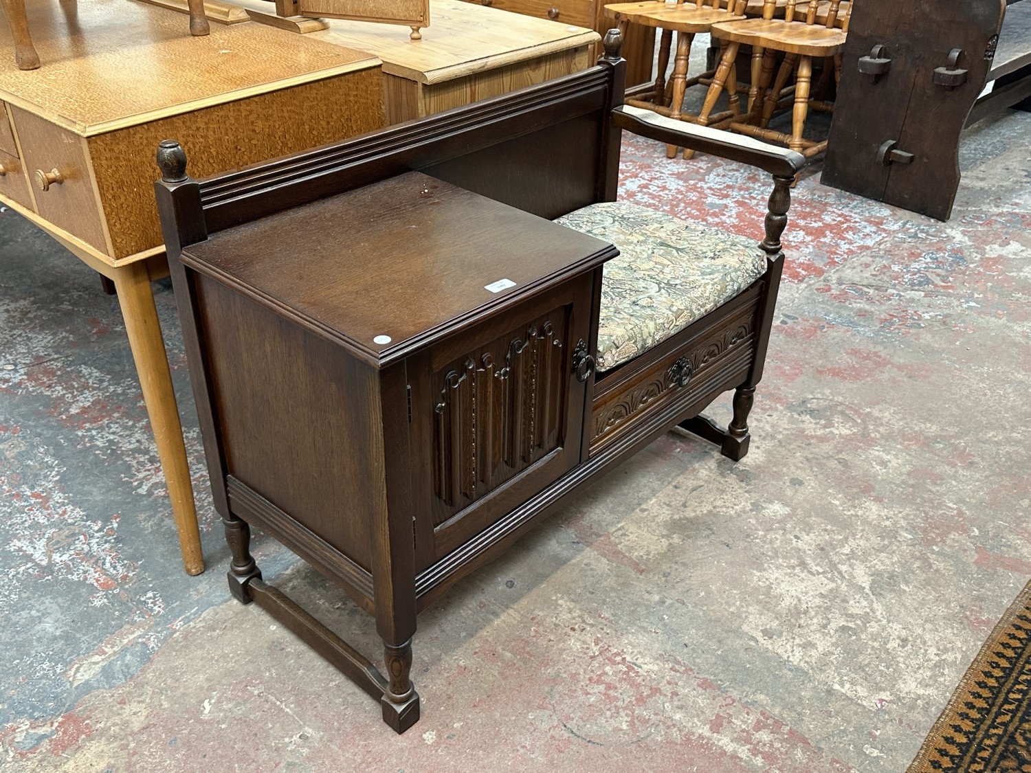 A carved oak linenfold telephone table - approx. 77cm high x 98cm wide ...