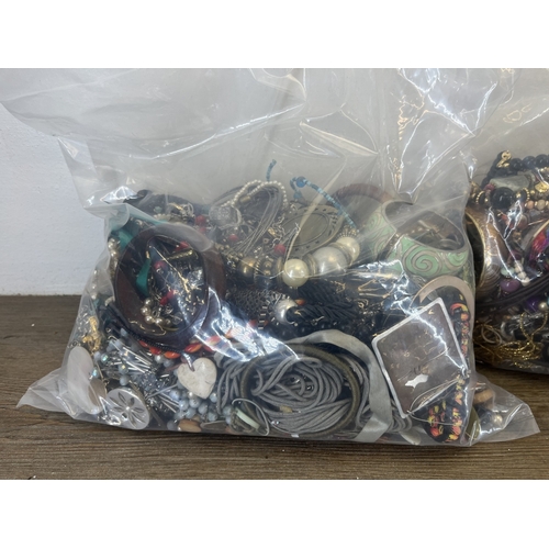 1357 - Four bags containing approx. 19kg of costume jewellery