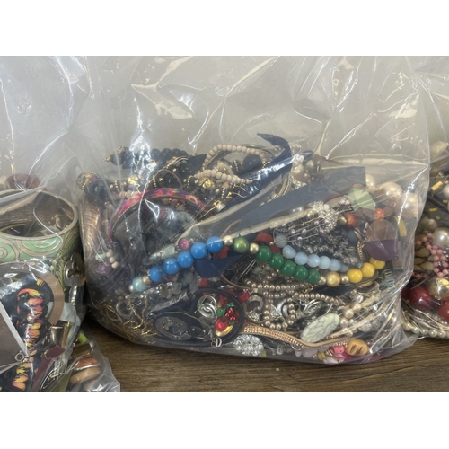 1357 - Four bags containing approx. 19kg of costume jewellery