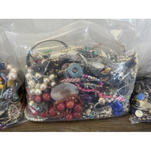1357 - Four bags containing approx. 19kg of costume jewellery
