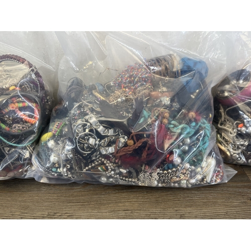 1358 - Four bags containing approx. 19kg of costume jewellery