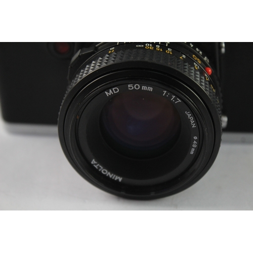 23 - A Minolta XG 9 35mm SLR camera fitted with MD 1:1.7 50mm lens
