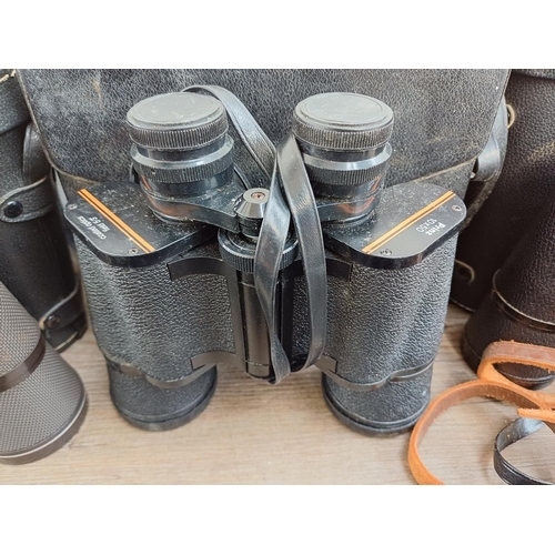 84 - Twelve pairs of binoculars to include cased Optisan Leo-III 8x40, Hilkinson Ultra V 9x35 wide angle,... 