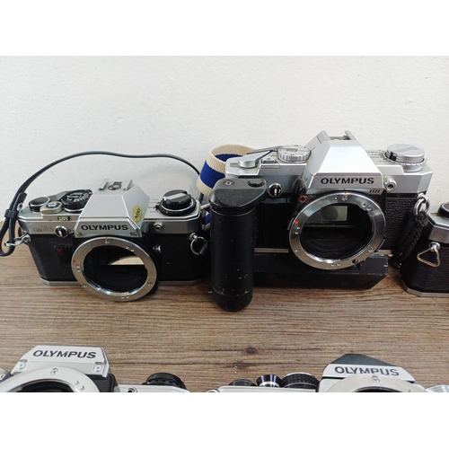 101 - Nine Olympus 35mm SLR camera bodies, five OM10, one OM-2 (A/F), one OM30 and two OM20