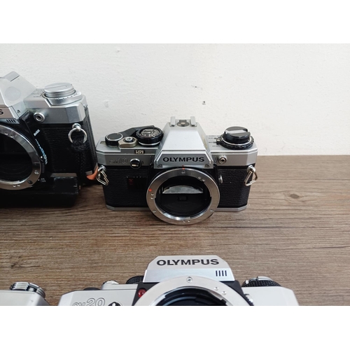 101 - Nine Olympus 35mm SLR camera bodies, five OM10, one OM-2 (A/F), one OM30 and two OM20