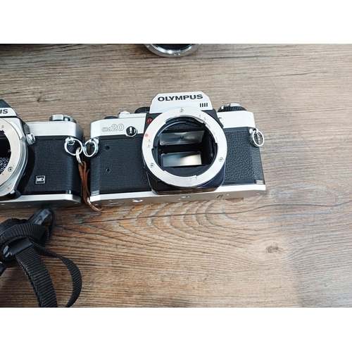 101 - Nine Olympus 35mm SLR camera bodies, five OM10, one OM-2 (A/F), one OM30 and two OM20