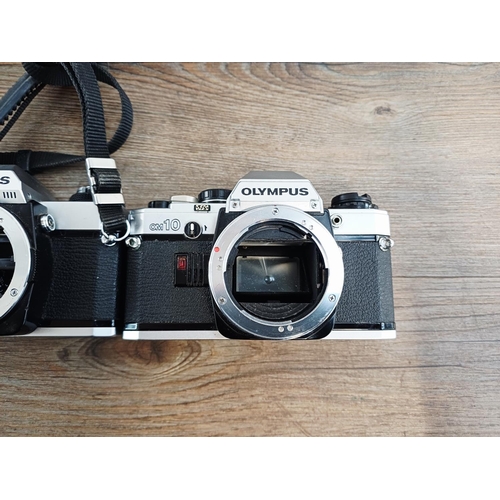 101 - Nine Olympus 35mm SLR camera bodies, five OM10, one OM-2 (A/F), one OM30 and two OM20