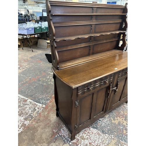 21 - A mid 20th century Ercol style oak dresser - approx. 158cm high x 133cm wide x 50cm deep