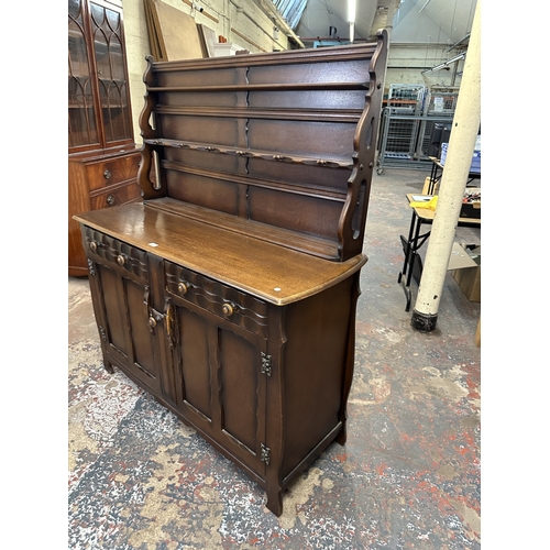 21 - A mid 20th century Ercol style oak dresser - approx. 158cm high x 133cm wide x 50cm deep