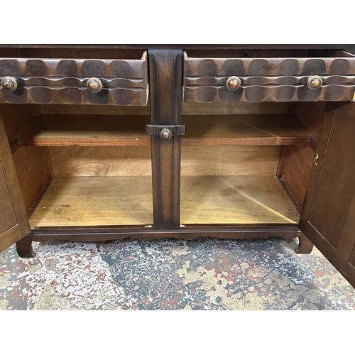 21 - A mid 20th century Ercol style oak dresser - approx. 158cm high x 133cm wide x 50cm deep