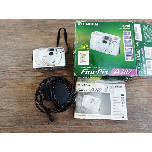 118 - Two boxed Fujifilm FinePix CCD sensor compact digital cameras, one F50fd 12mp with two batteries, ch... 