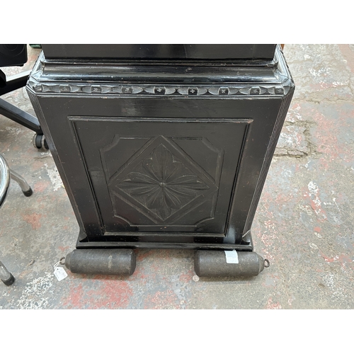 10 - A Georgian Cooper of Newport ebonised and carved oak cased grandfather clock with hand painted ename... 