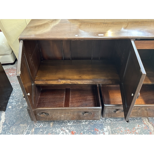 16 - An Ercol Model 468 elm sideboard - approx. 76cm high x 128cm wide x 43cm deep