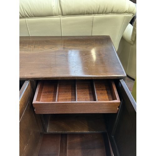 16 - An Ercol Model 468 elm sideboard - approx. 76cm high x 128cm wide x 43cm deep