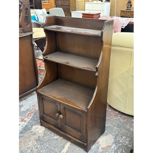 17 - An Ercol Model 476 elm waterfall bookcase - approx. 111cm high x 61cm wide x 34cm deep