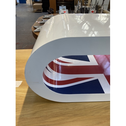 22 - A Zespoke high gloss white hoop coffee table/TV stand with Union Jack design - approx. 36cm high x 9... 
