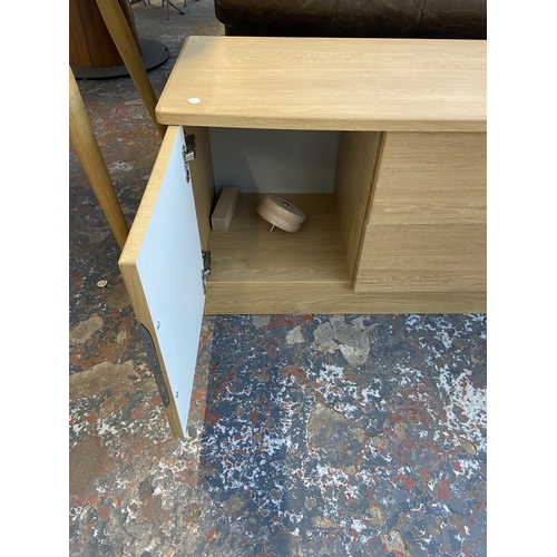 23 - A modern oak effect TV stand - approx. 51cm high x 145cm wide x 42cm deep