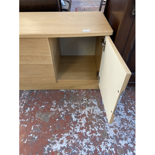 23 - A modern oak effect TV stand - approx. 51cm high x 145cm wide x 42cm deep