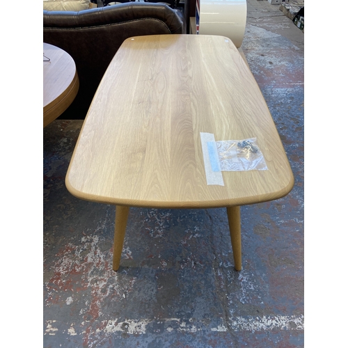 24 - A modern Ercol style ash plank dining table - approx. 75cm high x 77cm wide x 150cm long