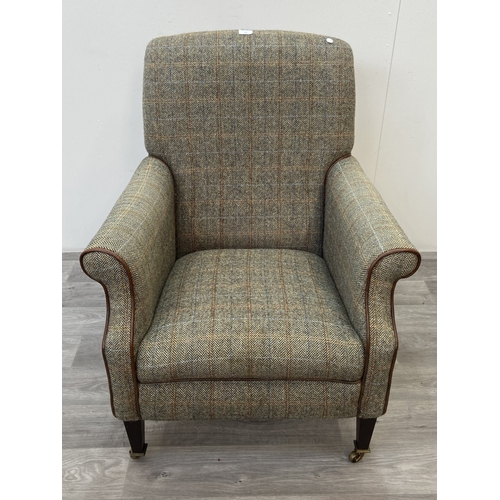 29 - A Tetrad Harris Tweed 100% pure new wool hand woven cloth armchair on beech supports and brass casto... 
