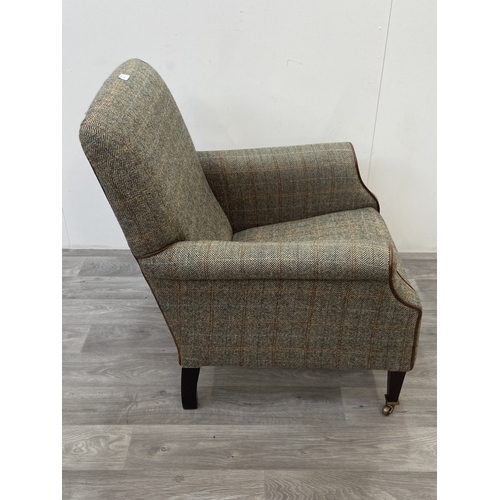 29 - A Tetrad Harris Tweed 100% pure new wool hand woven cloth armchair on beech supports and brass casto... 