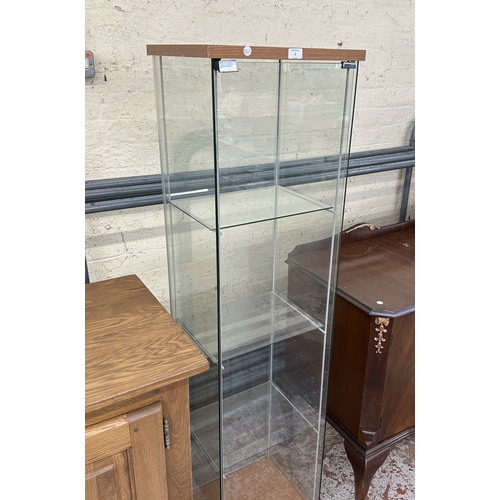 3 - A modern beech effect and glass display cabinet with three glass shelves - approx. 163cm high x 42.5... 